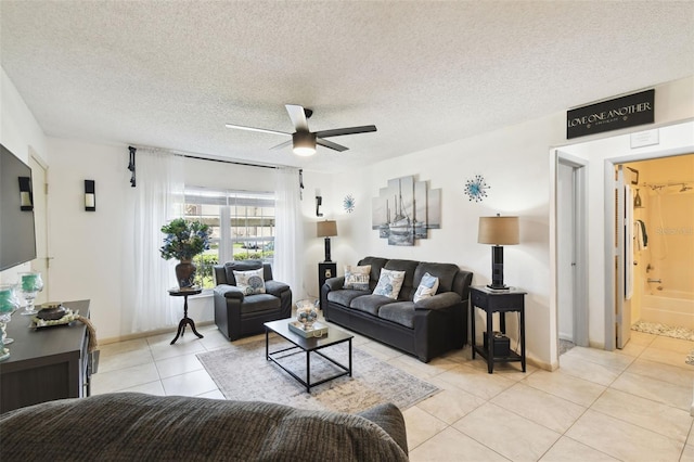 6630 Spring Flower Dr Unit 14, New Port Richey, FL 34653 - living room featuring a ceiling fan, light tile patterned flooring, a textured ceiling, and baseboards