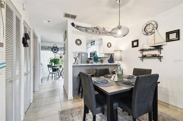 6630 Spring Flower Dr Unit 14, New Port Richey, FL 34653 - dining room featuring light tile patterned floors and baseboards