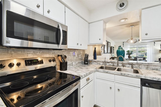 6630 Spring Flower Dr Unit 14, New Port Richey, FL 34653 - kitchen featuring appliances with stainless steel finishes, a sink, light countertops, and backsplash