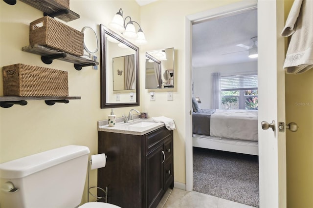 6630 Spring Flower Dr Unit 14, New Port Richey, FL 34653 - ensuite bathroom featuring vanity, toilet, and tile patterned flooring