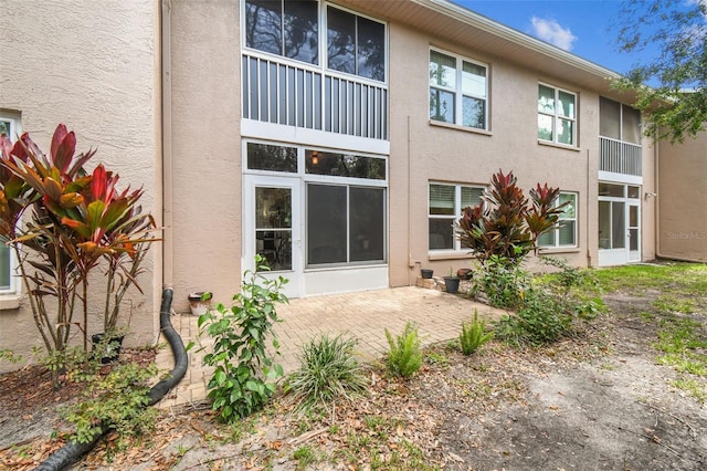 6630 Spring Flower Dr Unit 14, New Port Richey, FL 34653 - rear view of house with stucco siding and a patio area