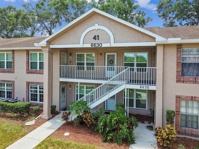 6630 Spring Flower Dr Unit 14, New Port Richey, FL 34653 - view of building exterior with stairs