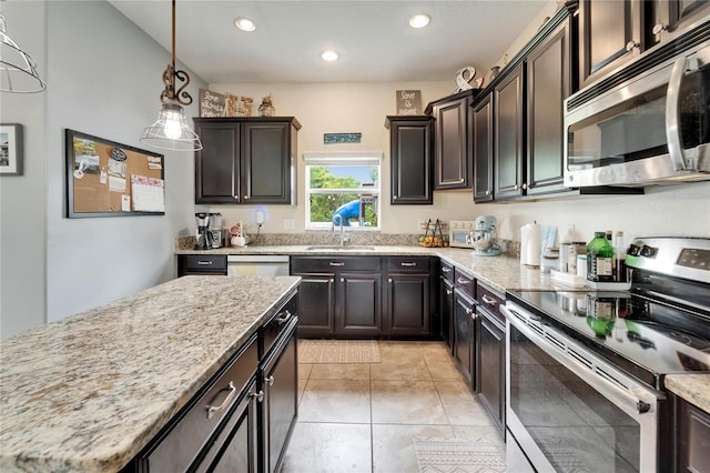 12316 Streambed Dr, Riverview, FL 33579 - kitchen featuring appliances with stainless steel finishes, a sink, recessed lighting, light stone counters, and hanging light fixtures