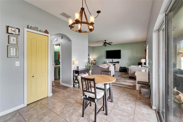 12316 Streambed Dr, Riverview, FL 33579 - dining space with arched walkways, ceiling fan, a chandelier, and light tile patterned floors