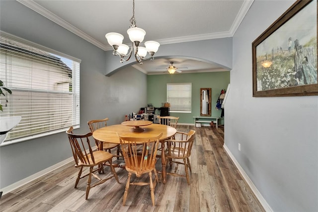12316 Streambed Dr, Riverview, FL 33579 - dining area featuring arched walkways, ceiling fan, wood finished floors, a chandelier, and ornamental molding