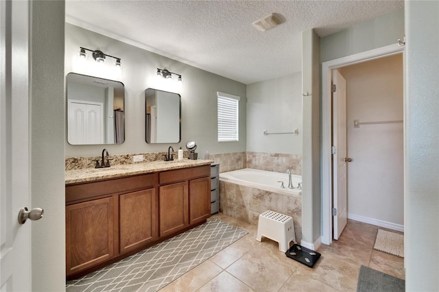 12316 Streambed Dr, Riverview, FL 33579 - full bath with a garden tub, double vanity, a textured ceiling, and tile patterned floors
