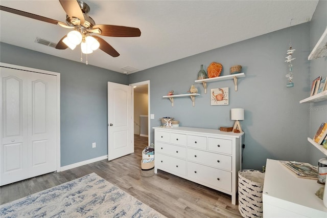 12316 Streambed Dr, Riverview, FL 33579 - bedroom with light wood-style flooring, a ceiling fan, and baseboards