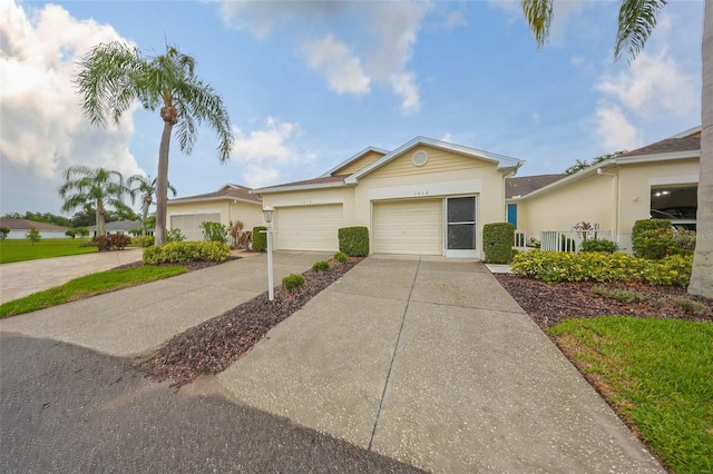 1012 Radison Lake Ct Unit 59, Sun City Center, FL 33573 - ranch-style house with concrete driveway, an attached garage, and stucco siding