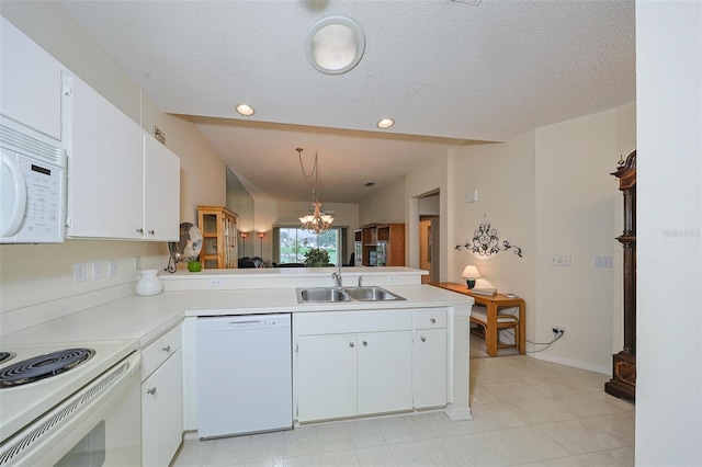 1012 Radison Lake Ct Unit 59, Sun City Center, FL 33573 - kitchen featuring white appliances, a sink, a peninsula, light countertops, and white cabinetry