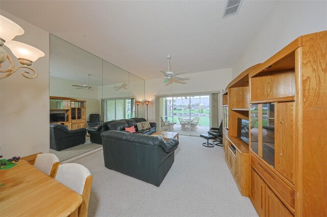 1012 Radison Lake Ct Unit 59, Sun City Center, FL 33573 - living area with light carpet, ceiling fan, and a textured ceiling