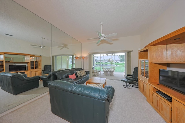 1012 Radison Lake Ct Unit 59, Sun City Center, FL 33573 - living area with light colored carpet, ceiling fan, and a textured ceiling