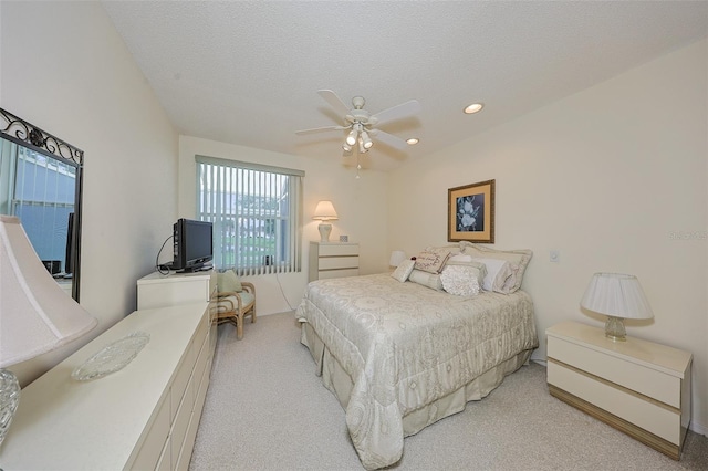 1012 Radison Lake Ct Unit 59, Sun City Center, FL 33573 - bedroom with light carpet, recessed lighting, ceiling fan, and a textured ceiling