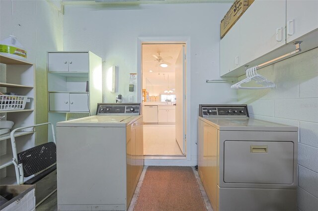1012 Radison Lake Ct Unit 59, Sun City Center, FL 33573 - laundry area featuring washer and dryer and cabinet space