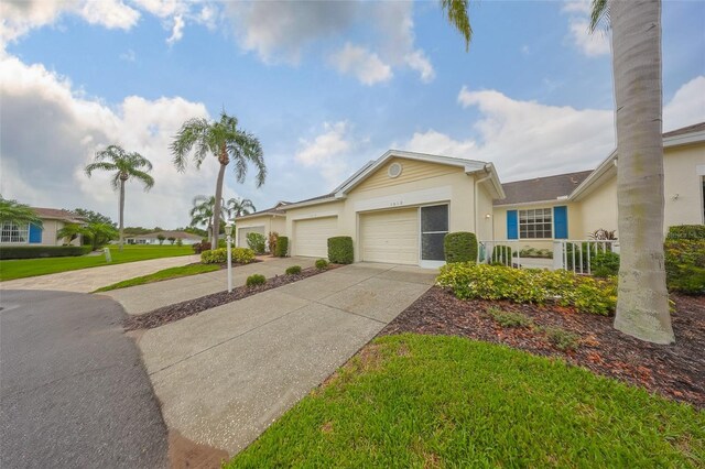 1012 Radison Lake Ct Unit 59, Sun City Center, FL 33573 - ranch-style home with concrete driveway, an attached garage, and stucco siding