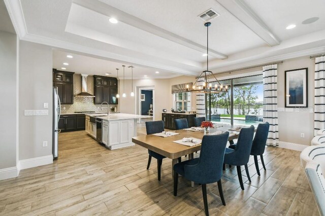 9080 Morgana Ct, Winter Garden, FL 34787 - dining area with light wood-style floors, a chandelier, beam ceiling, recessed lighting, and baseboards