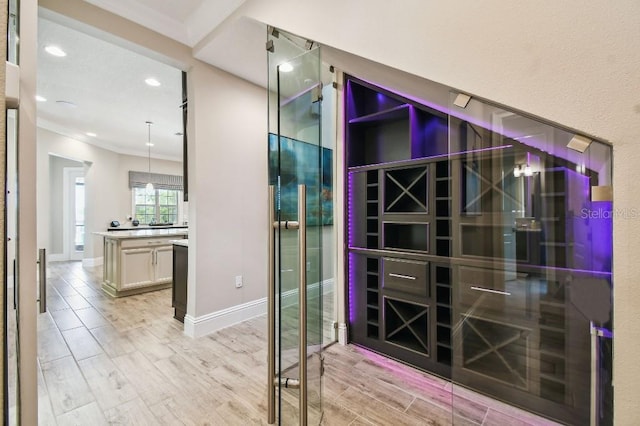 9080 Morgana Ct, Winter Garden, FL 34787 - wine room featuring crown molding, light wood-style flooring, recessed lighting, and baseboards