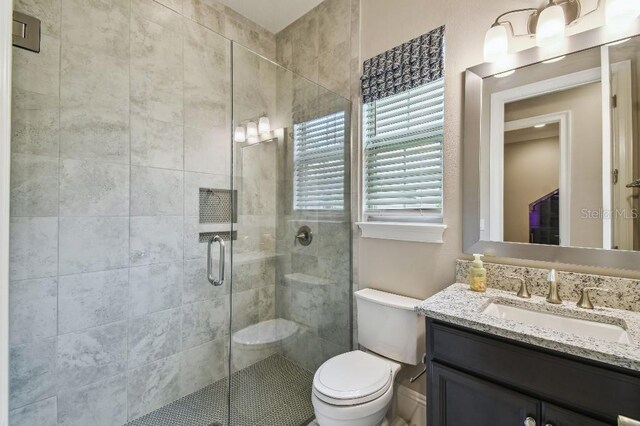 9080 Morgana Ct, Winter Garden, FL 34787 - bathroom featuring toilet, vanity, and a shower stall