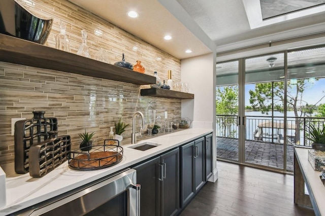9080 Morgana Ct, Winter Garden, FL 34787 - indoor wet bar featuring wine cooler, backsplash, wood finished floors, recessed lighting, and a water view