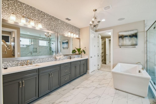 9080 Morgana Ct, Winter Garden, FL 34787 - full bathroom with a marble finish shower, marble look tiles, a chandelier, double vanity, and a soaking tub