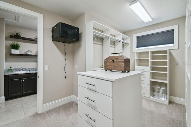 9080 Morgana Ct, Winter Garden, FL 34787 - walk in closet with a sink, light carpet, and light tile patterned floors