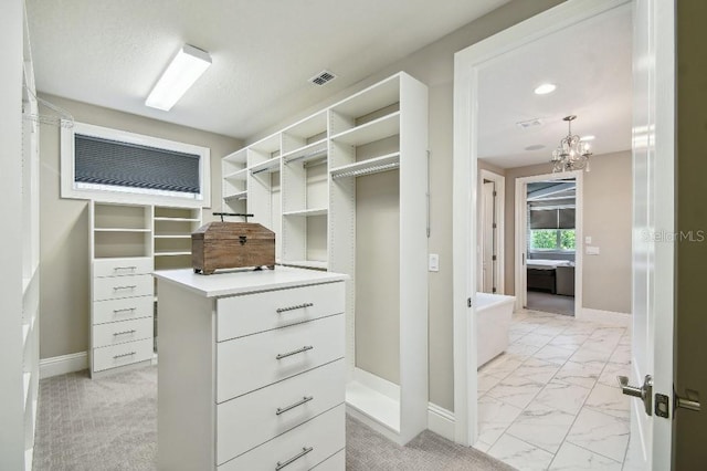 9080 Morgana Ct, Winter Garden, FL 34787 - walk in closet with light marble finish floors and a chandelier