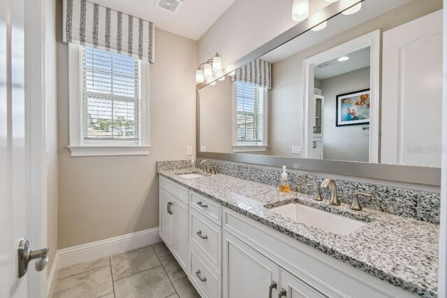 9080 Morgana Ct, Winter Garden, FL 34787 - bathroom featuring baseboards, double vanity, and plenty of natural light
