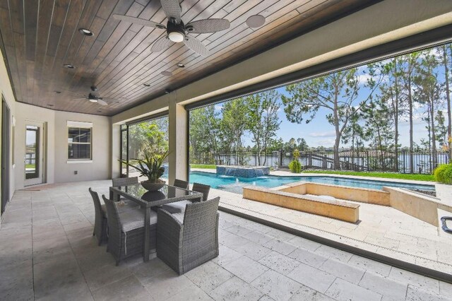 9080 Morgana Ct, Winter Garden, FL 34787 - fenced backyard featuring a ceiling fan, a patio area, outdoor dining area, and a pool with connected hot tub