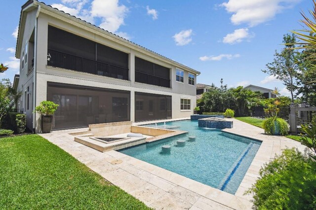 9080 Morgana Ct, Winter Garden, FL 34787 - rear view of house featuring stucco siding, a lawn, a patio, and a pool with connected hot tub