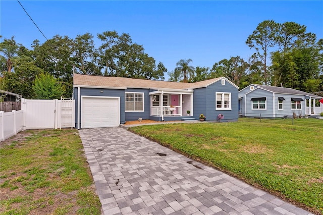 4012 N Munro St, Tampa, FL 33603 - ranch-style home featuring covered porch, an attached garage, driveway, and a gate
