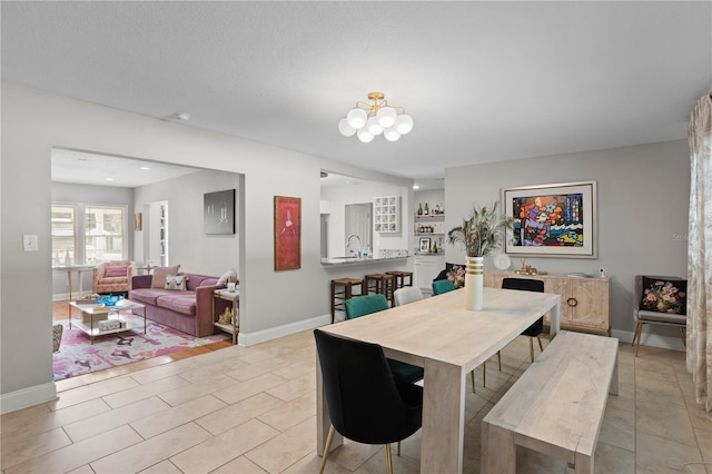 4012 N Munro St, Tampa, FL 33603 - dining space with light tile patterned floors and a chandelier
