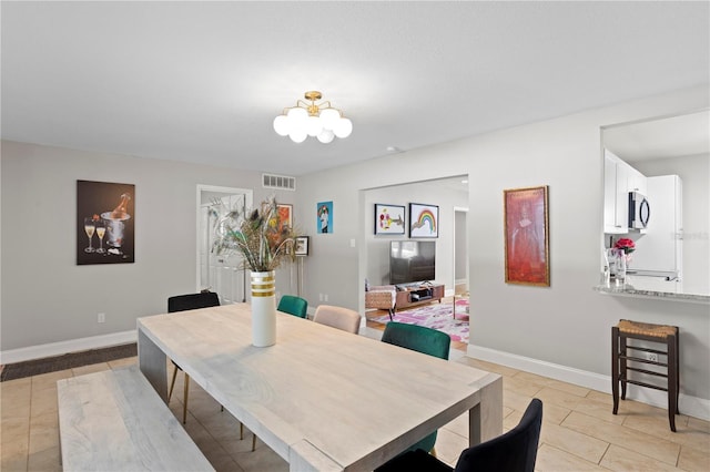 4012 N Munro St, Tampa, FL 33603 - dining space with a chandelier and light tile patterned floors