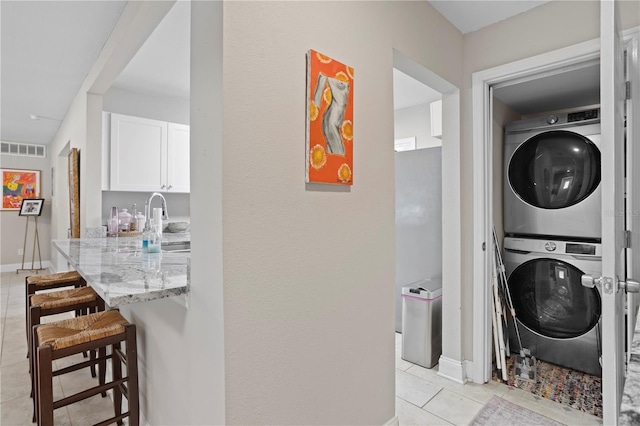 4012 N Munro St, Tampa, FL 33603 - washroom with stacked washer / dryer and light tile patterned floors