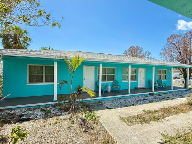 412 73rd Ave, St Pete Beach, FL 33706 - single story home featuring a porch and a shingled roof