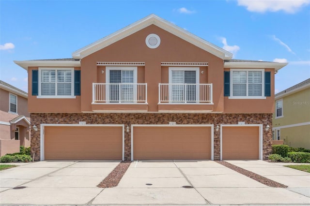 589 52nd Ave N, Saint Petersburg, FL 33703 - multi unit property featuring concrete driveway, a garage, stucco siding, and stone siding