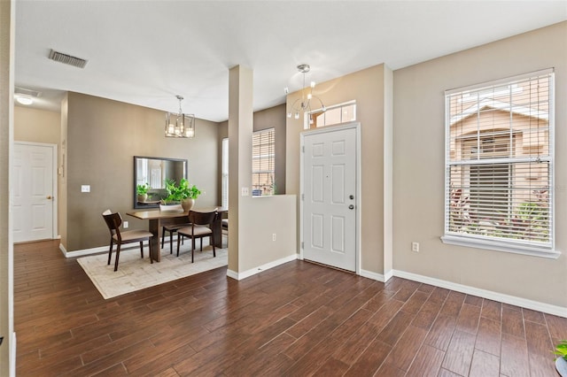 589 52nd Ave N, Saint Petersburg, FL 33703 - entrance foyer featuring a chandelier, dark wood-style floors, and baseboards