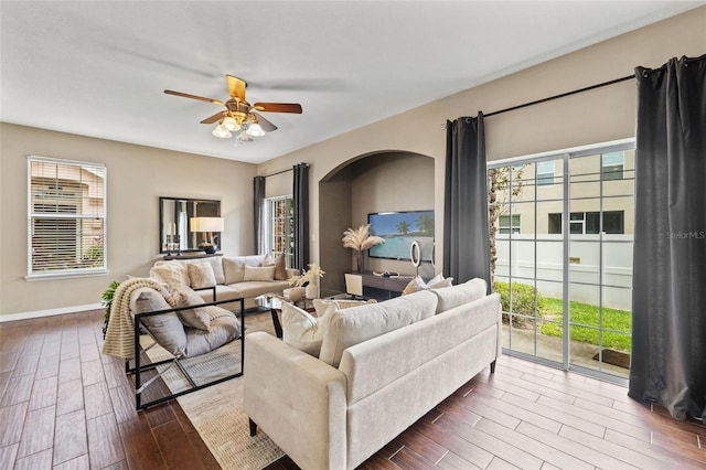 589 52nd Ave N, Saint Petersburg, FL 33703 - living area featuring dark wood-style floors, a ceiling fan, and plenty of natural light