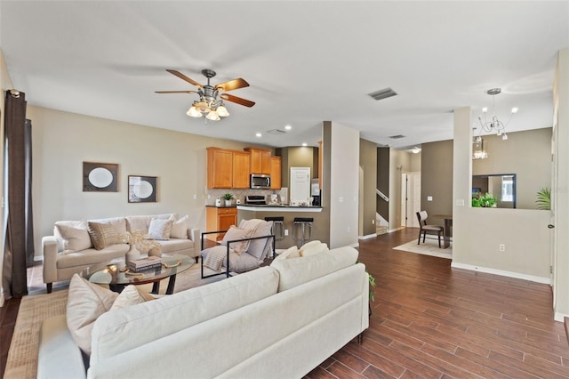589 52nd Ave N, Saint Petersburg, FL 33703 - living room with baseboards, dark wood-style floors, ceiling fan, and a chandelier