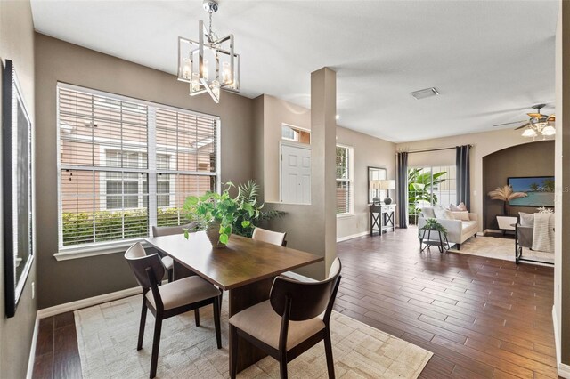 589 52nd Ave N, Saint Petersburg, FL 33703 - dining area featuring baseboards, wood finished floors, a chandelier, and a ceiling fan