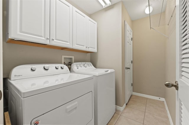 589 52nd Ave N, Saint Petersburg, FL 33703 - washroom with independent washer and dryer, cabinet space, light tile patterned flooring, and baseboards