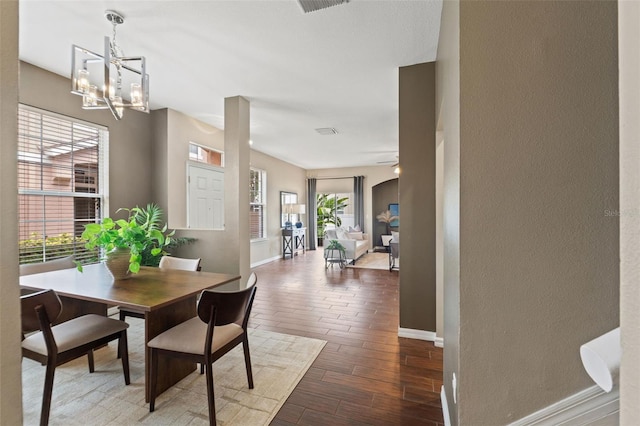 589 52nd Ave N, Saint Petersburg, FL 33703 - dining room featuring a chandelier, baseboards, wood finished floors, and a textured wall