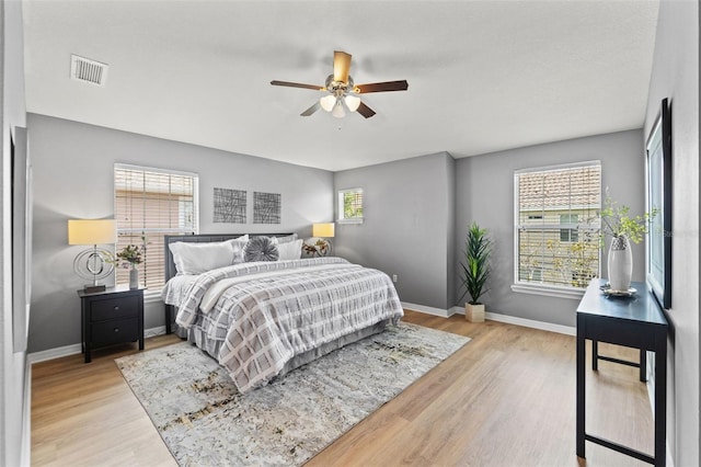 589 52nd Ave N, Saint Petersburg, FL 33703 - bedroom with baseboards, wood finished floors, and ceiling fan