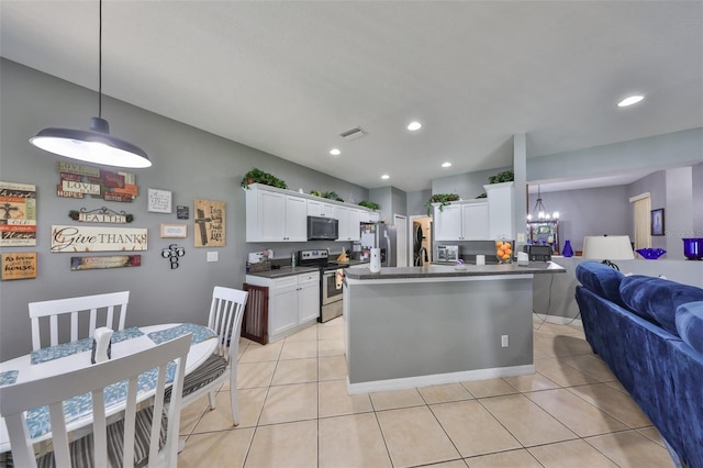 11806 Holly Crest Ln, Riverview, FL 33569 - kitchen featuring appliances with stainless steel finishes, open floor plan, dark countertops, a chandelier, and white cabinets