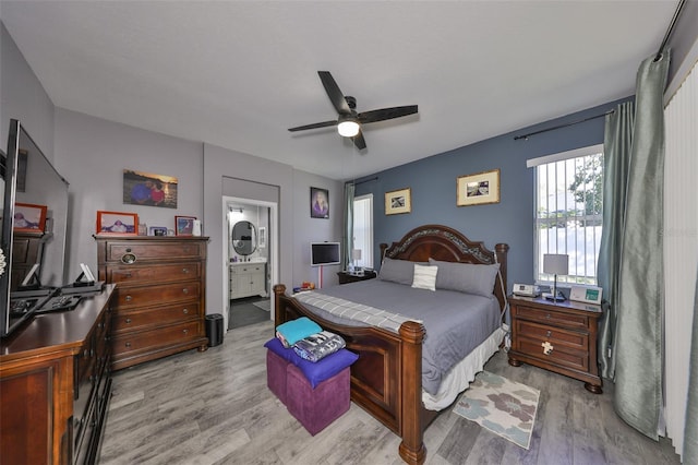 11806 Holly Crest Ln, Riverview, FL 33569 - bedroom with light wood-type flooring, ensuite bath, and a ceiling fan