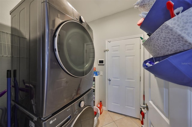 11806 Holly Crest Ln, Riverview, FL 33569 - washroom featuring stacked washing machine and dryer and light tile patterned floors