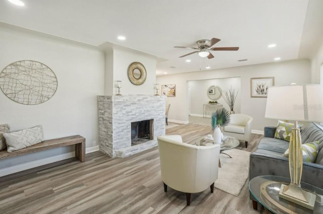 3118 Adrian Ave, Largo, FL 33774 - living area featuring a ceiling fan, wood finished floors, baseboards, a stone fireplace, and recessed lighting