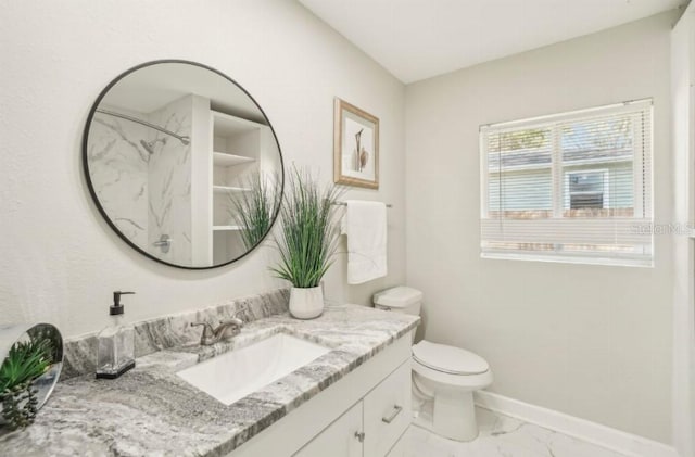 3118 Adrian Ave, Largo, FL 33774 - full bath featuring marble look tiles, vanity, baseboards, toilet, and a shower