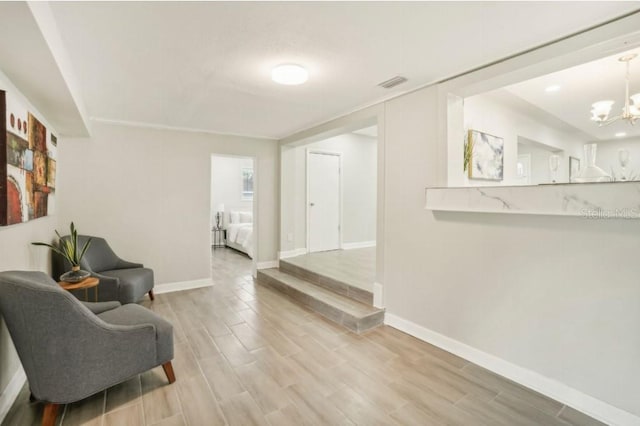 3118 Adrian Ave, Largo, FL 33774 - sitting room featuring a chandelier, wood finished floors, and baseboards