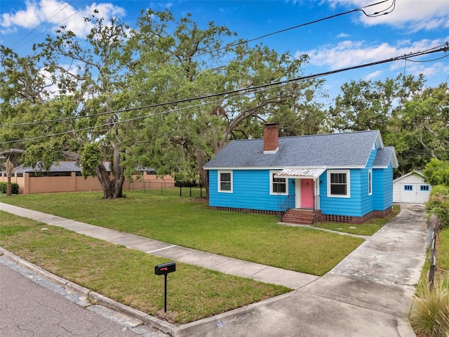 320 Broadway, Dunedin, FL 34698 - view of front of home with a shingled roof, entry steps, a chimney, concrete driveway, and a detached garage