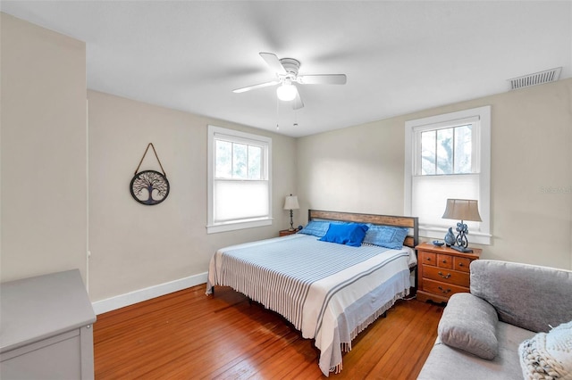 320 Broadway, Dunedin, FL 34698 - bedroom featuring multiple windows, wood-type flooring, baseboards, and ceiling fan