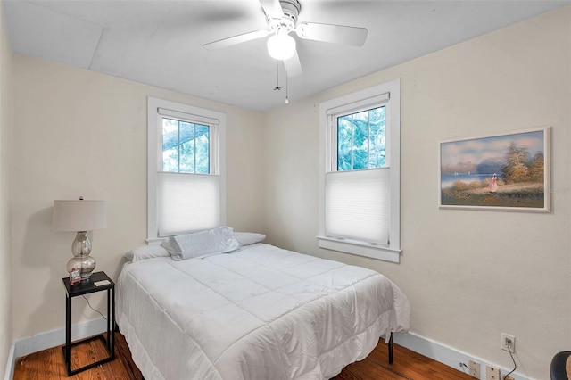 320 Broadway, Dunedin, FL 34698 - bedroom featuring baseboards, wood finished floors, and a ceiling fan